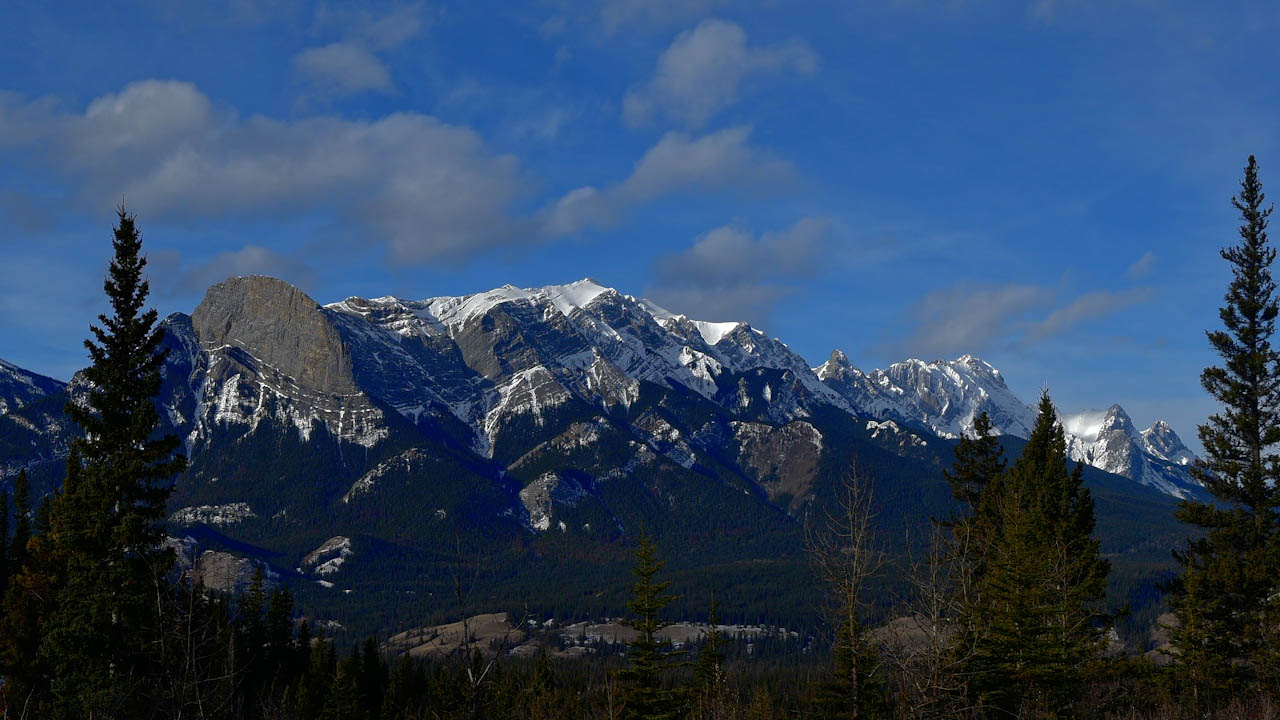 Light clouds over Canadian Rockies and cliffs