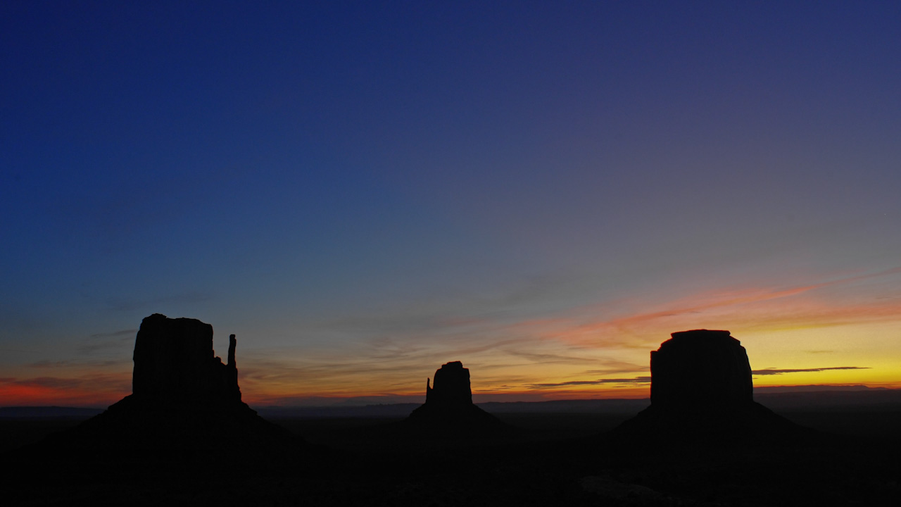 Moon sets, then the sun, over Monument Valley’s monoliths