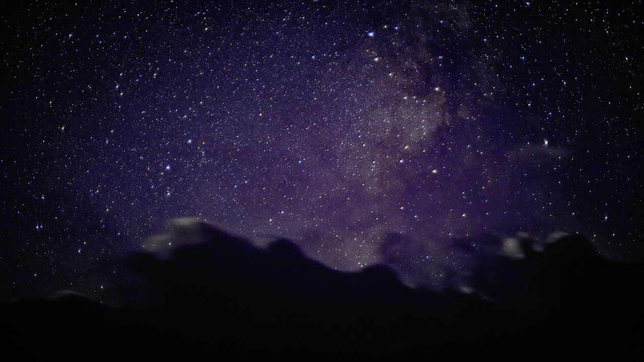 Above mountains, above clouds, the night sky…